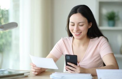 woman text and looking at email receipt on mobile phone